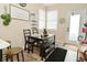 Cozy dining area features wood-style flooring, dining table set, bench seating, and natural light from a window at 15524 Dusty Trl, Noblesville, IN 46060