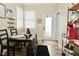 Bright dining area with wood floors, dark table, and access to the backyard offers a cozy space for meals at 15524 Dusty Trl, Noblesville, IN 46060