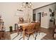 Elegant dining room with wood table, seating for six, stylish light fixture, and neutral tones for cozy meals at 15524 Dusty Trl, Noblesville, IN 46060