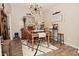 Dining room features wood floors, a modern light fixture, and a wooden dining table set at 15524 Dusty Trl, Noblesville, IN 46060