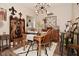 Dining room boasts a wood table, four chairs, a decorative runner and modern light fixture at 15524 Dusty Trl, Noblesville, IN 46060