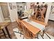 Dining room boasts a wood table, four chairs, a decorative runner and access to other rooms at 15524 Dusty Trl, Noblesville, IN 46060