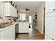 Spacious kitchen with white cabinets, modern appliances, and wood-style flooring providing ample room for cooking and dining at 15524 Dusty Trl, Noblesville, IN 46060