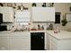 Clean kitchen with white cabinets and black appliances, and modern fixtures create a bright and efficient cooking space at 15524 Dusty Trl, Noblesville, IN 46060