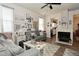 Cozy living room with fireplace and view into the kitchen area at 15524 Dusty Trl, Noblesville, IN 46060