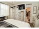 Bright main bedroom features wood floors, a desk, a view to an ensuite bathroom, and natural light at 15524 Dusty Trl, Noblesville, IN 46060