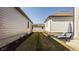 Well-maintained backyard featuring green grass, a lounge set, and a neatly landscaped exterior at 15628 Allegro Dr, Westfield, IN 46074