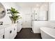 Bright bathroom boasts double sinks, a freestanding tub, and a glass-enclosed shower at 15628 Allegro Dr, Westfield, IN 46074