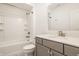 Bright bathroom boasts white subway tile in the shower and updated gray vanity with modern hardware at 15628 Allegro Dr, Westfield, IN 46074