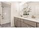 Bathroom featuring a double vanity, a large mirror and a shower and bathtub, all in neutral white and gray tones at 15628 Allegro Dr, Westfield, IN 46074