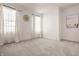 A bright bedroom with two windows, neutral walls, soft carpeting, and a decorative circular wall hanging at 15628 Allegro Dr, Westfield, IN 46074