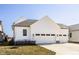 Charming home showcasing a two-car garage, neat landscaping, and a pristine driveway at 15628 Allegro Dr, Westfield, IN 46074
