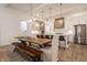 Bright kitchen and dining area featuring an island, stainless appliances, and a large rustic dining table at 15628 Allegro Dr, Westfield, IN 46074