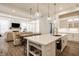 Open-concept living area with modern lighting, and spacious island offering a seamless flow for entertaining at 15628 Allegro Dr, Westfield, IN 46074