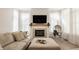 Inviting living room with a fireplace, large windows, and a comfortable sofa at 15628 Allegro Dr, Westfield, IN 46074