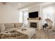Bright living room featuring a cozy fireplace, comfortable seating, and natural light at 15628 Allegro Dr, Westfield, IN 46074