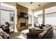 Covered patio boasts a brick fireplace, mounted TV, and comfortable lounge furniture for relaxing outdoors at 15628 Allegro Dr, Westfield, IN 46074