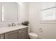 Chic powder room features a gray vanity, white countertop, and a stylish framed mirror at 15628 Allegro Dr, Westfield, IN 46074