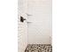 Modern shower features white subway tile and a pebble floor for a sleek, updated look at 15628 Allegro Dr, Westfield, IN 46074