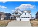 Beautiful two-story home with a well-manicured lawn, attached two-car garage, and appealing architectural features at 16516 Wilsons Farm Dr, Fortville, IN 46040