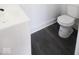 Bathroom featuring modern fixtures, vinyl flooring, and a clean, minimalist design at 1715 Fletcher Ave, Indianapolis, IN 46203