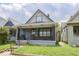 Charming home featuring a covered front porch and classic architectural details at 1715 Fletcher Ave, Indianapolis, IN 46203