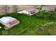 Aerial showcasing the farmhouse and outbuilding plus landscaping at 18103 N 300 W, Summitville, IN 46070