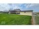 A sprawling backyard features a large outbuilding with metal roof, a large star, and plentiful green space at 18103 N 300 W, Summitville, IN 46070