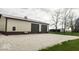 Large detached garage with two doors and ample parking space in front with bench at 18103 N 300 W, Summitville, IN 46070