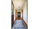 Inviting hallway with hardwood floors, decorative wallpaper, and wood trim at 18103 N 300 W, Summitville, IN 46070