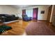 A cozy living room features hardwood floors, plush seating, and natural light filtering through the windows at 18103 N 300 W, Summitville, IN 46070