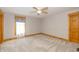 Bright bedroom featuring soft carpet, natural trim, and a ceiling fan at 241 S Walnut St, Jamestown, IN 46147