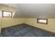 Spacious bedroom with a vaulted ceiling, blue carpet, and natural light from the windows at 241 S Walnut St, Jamestown, IN 46147