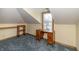 Bedroom with sloped ceilings features an antique desk, carpet, and natural lighting at 241 S Walnut St, Jamestown, IN 46147