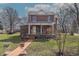 Charming two-story brick home featuring a welcoming front porch and walkway at 241 S Walnut St, Jamestown, IN 46147