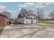 Detached two-car garage featuring white siding, carriage doors, and a concrete driveway at 241 S Walnut St, Jamestown, IN 46147