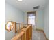 Upstairs hallway with unique octagon window and wood trim on window and staircase at 241 S Walnut St, Jamestown, IN 46147