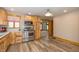 Well-lit kitchen boasting stainless steel appliances, wood cabinets, and a view to the living room at 241 S Walnut St, Jamestown, IN 46147