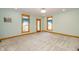 Spacious room featuring a light-blue wall color, carpeted floor, and wood trim at 241 S Walnut St, Jamestown, IN 46147