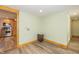 Bright room with vinyl flooring, wood trim, and a pass-through to the kitchen at 241 S Walnut St, Jamestown, IN 46147