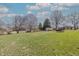 Large lot showing the expansive lawn, mature trees, and storage sheds at 241 S Walnut St, Jamestown, IN 46147
