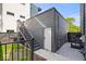 Backyard featuring an exterior staircase to a back entrance and black metal fencing at 244 N Summit St, Indianapolis, IN 46201