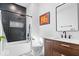 Modern bathroom with a soaking tub, black tile accents, and stylish vanity at 244 N Summit St, Indianapolis, IN 46201
