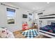 Bright bedroom with a bunk bed, two large windows, and a playful checkered rug at 244 N Summit St, Indianapolis, IN 46201