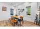 Bright dining area with modern light fixture, wood table, and a large window at 244 N Summit St, Indianapolis, IN 46201
