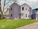 Modern two-story home featuring clean lines, fresh landscaping, and a charming front porch seating area at 244 N Summit St, Indianapolis, IN 46201