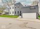Charming two-story home featuring an attached garage and well-maintained landscaping at 244 N Summit St, Indianapolis, IN 46201