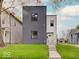 Modern two-story home featuring clean lines and a well-manicured front yard and landscaping at 244 N Summit St, Indianapolis, IN 46201