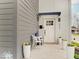Charming front entrance featuring stylish planters, modern lighting and a cozy seating arrangement at 244 N Summit St, Indianapolis, IN 46201