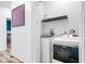 Convenient laundry room featuring modern appliances and practical shelving for storage at 244 N Summit St, Indianapolis, IN 46201